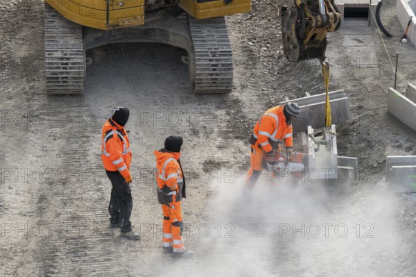 Construction workers in protective clothing work with machines on a dusty construction site, cut-off machines, Untertürkheim parking lot, Stuttgart, Baden-Württemberg, Germany