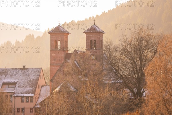 Church towers and buildings in a snowy village near Bergen, Black Forest, Germany