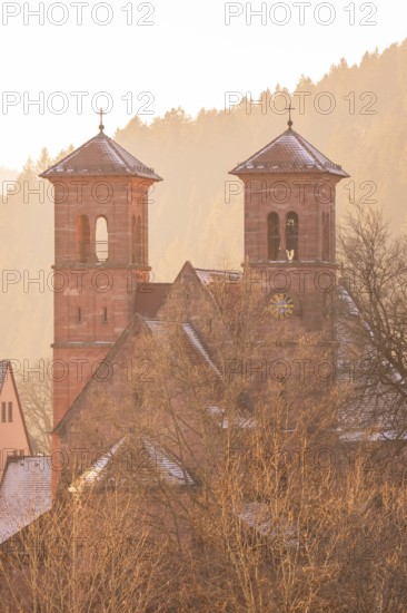 Church towers in a snowy village at sunrise, Black Forest, Germany