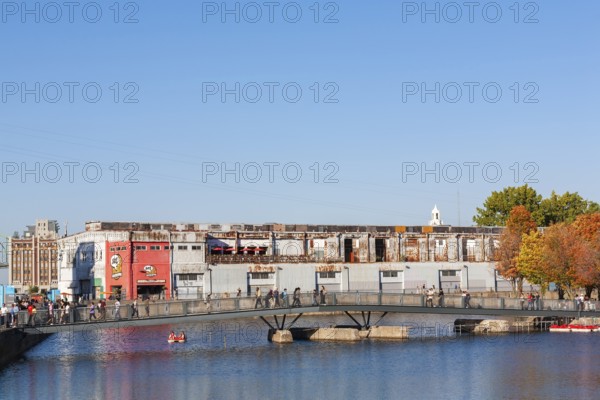 Pedestrian walkway bridge over Bonsecours basin leading to Parc du Bassin Bonsecours in autumn, Old Port of Montreal, Quebec, Canada