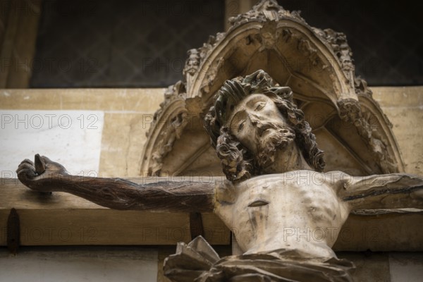 Christ sculpture from the former monastery church of S. Johannes Baptistam above portal of the monastery church, Blaubeuren Abbey, Swabian Jura, Baden-Württemberg, Germany