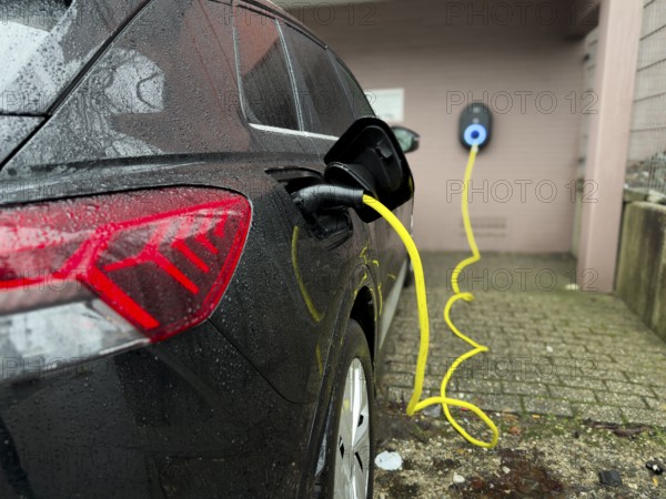 An e-car is charged at a wallbox, Wuppertal, Germany