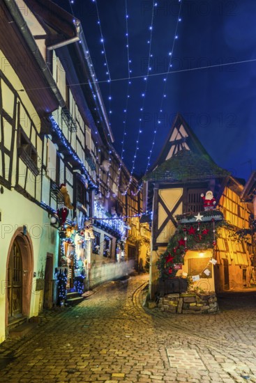 Houses illuminated and decorated for Christmas, Christmas market, blue hour, Eguisheim, Haut-Rhin department, Grand Est region, Alsace, France