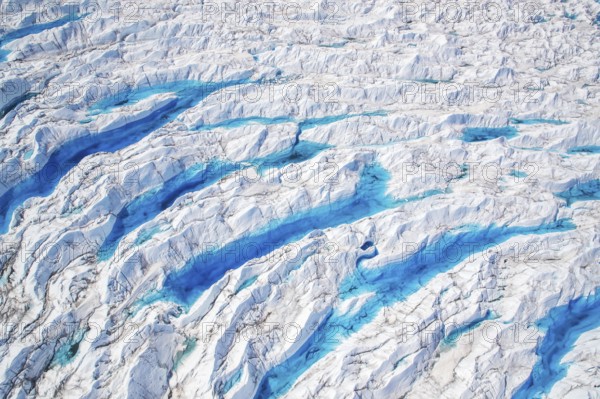 Aerial view of meltwater on the Greenland ice sheet, Arctic landscape, frozen wilderness, glaciers and snow-covered terrain, Climate change, Global warming, Greenland, North America