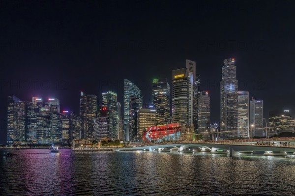 Skyline of the Central Business District, CBD with illuminated skyscrapers and Jubilee Bridge in the city Singapore at night, Southeast Asia