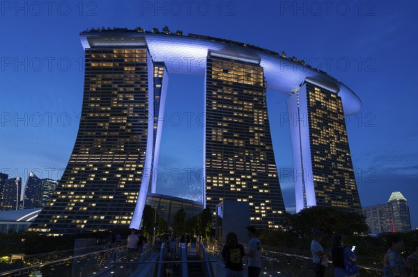 Marina Bay Sands, MBS, luxury 5-star hotel and integrated resort illuminated at dusk in Downtown Core of the city Singapore, Southeast Asia