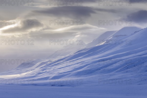 Snow covered mountain peaks along Adventdalen, Advent Valley near Longyearbyen at sunset in spring, Spitsbergen, Svalbard, Norway