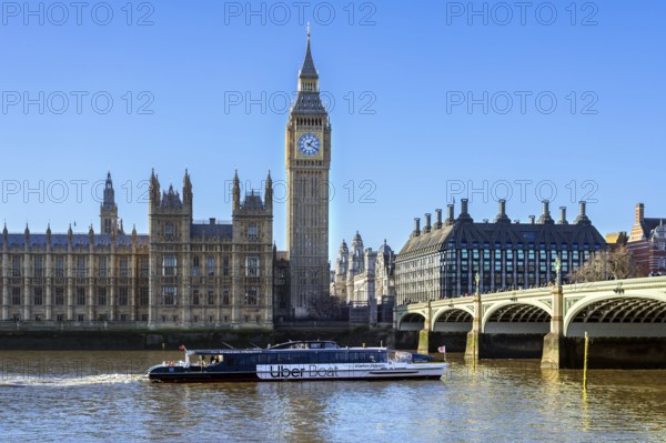 Uber Boat river bus by Thames Clippers on River Thames, Westminster Bridge, Elizabeth Tower, Big Ben and Palace of Westminster in London, England, UK