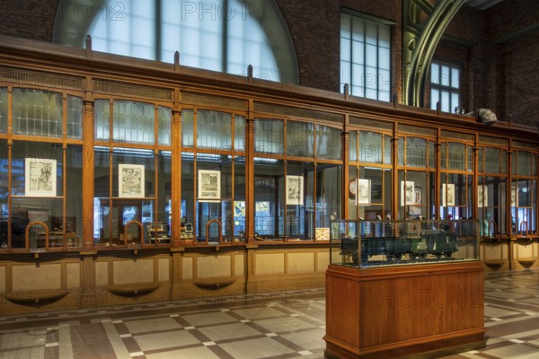 Former ticket hall with ticket counters and offices of the Schaerbeek railway station at Train World, railway museum in Schaarbeek, Brussels, Belgium