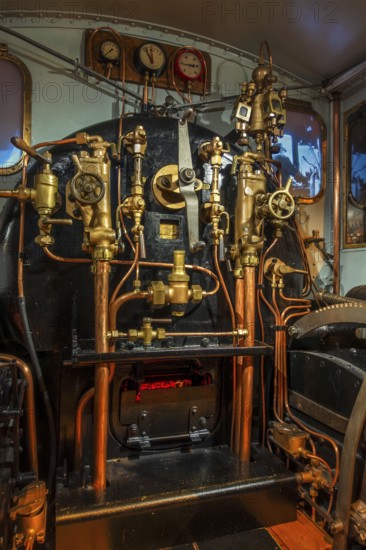Pressure gauges and valves in steam engine cab, driver's compartment of steam locomotive at Train World, railway museum in Schaarbeek, Belgium