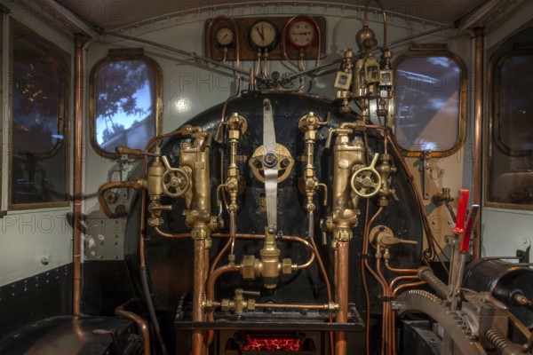Pressure gauges and valves in steam engine cab, driver's compartment of steam locomotive at Train World, railway museum in Schaarbeek, Belgium