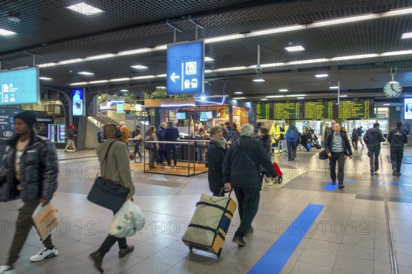 Travelers, commuters, tourists in the main hall of the NMBS Brussels-South railway station, Gare de Bruxelles-Midi in the city Brussels, Belgium