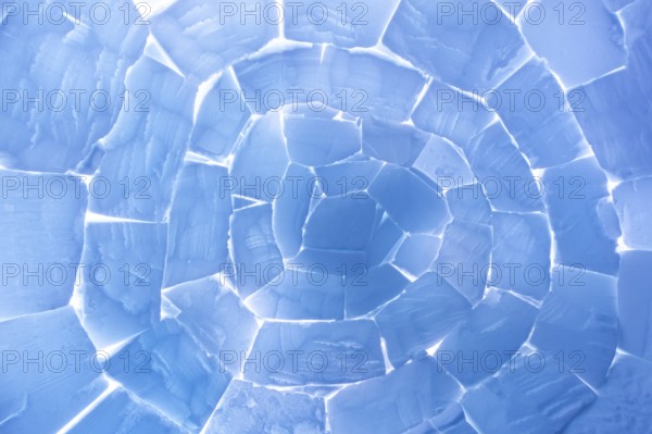 Interior of igloo showing roof built from stacked snow bricks in a catenary, curved shape resembling a paraboloid on Svalbard, Spitsbergen, Norway