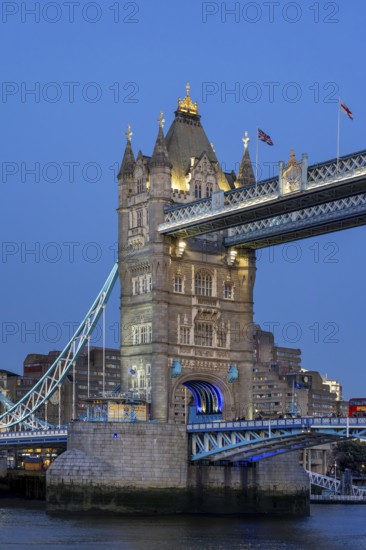 19th century Tower Bridge, neo-Gothic bascule / suspension bridge crossing the River Thames in the capital city London at dusk, England, UK
