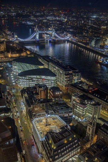 Aerial view from Sky Garden over Tower Bridge, the River Thames and illuminated highrise buildings in the capital city London at night, England, UK