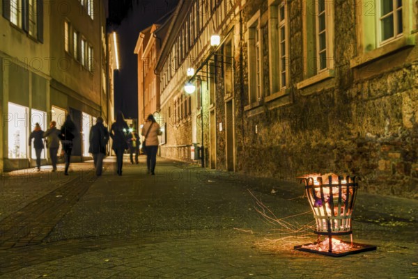Firebaskets and passers-by set the scene during the long shopping night in the city center of Reutlingen, Baden-Württemberg, Germany, for editorial use only