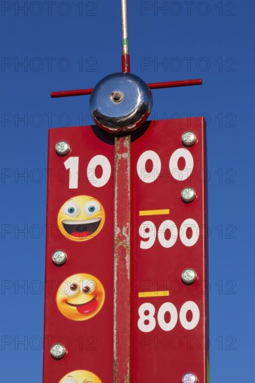 Close-up of High Striker game of strength with numbered score levels at Fun Show traveling amusement ride park, Old Port of Montreal, Quebec, Canada