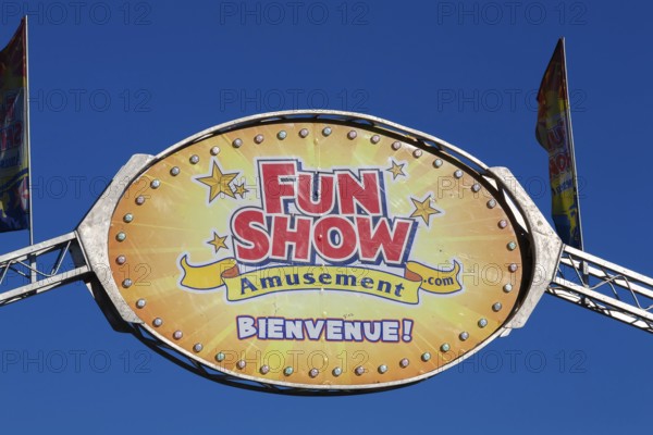 Close-up of Fun Show traveling amusement ride park banner with French word bienvenue spelled out in bold white letters, Old Port of Montreal, Quebec, Canada