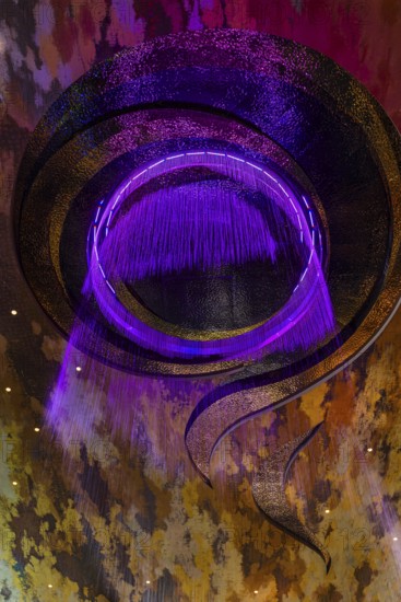 Artificial, brightly lit waterfall, Magic Waterfall, falls from the ceiling of the Iconsiam shopping center, Bangkok, Thailand's metropolis