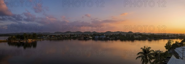 Scenic sunsets and colourful colonial architecture of historic center of Flores, Guatemala. View of lake Peten Itza, Flores Lake