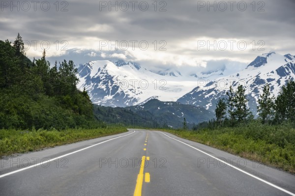 Road through mountain landscape, picturesque landscape with Worthington glacier, dramatic cloudy sky, Richardson Highway, Alaska, USA