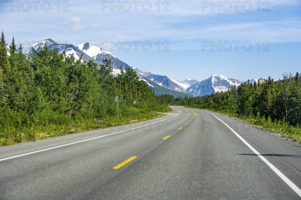 Road through taiga and mountainous landscape, picturesque landscape on Richardson Highway, Alaska, USA