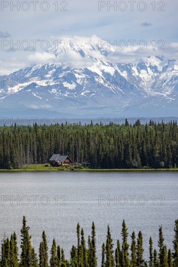 House on Lake Willow Lake, Taiga landscape with high glaciated mountain peak Mount Drum, Wrangell Mountains, Alaska, USA