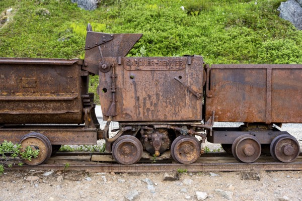 Old rusted mine trucks from the former Gold Mine Independence Mine in mountainous landscape, Independence Mine State Historical Park, Hatcher Pass, Talkeetna Mountains, Alaska, USA