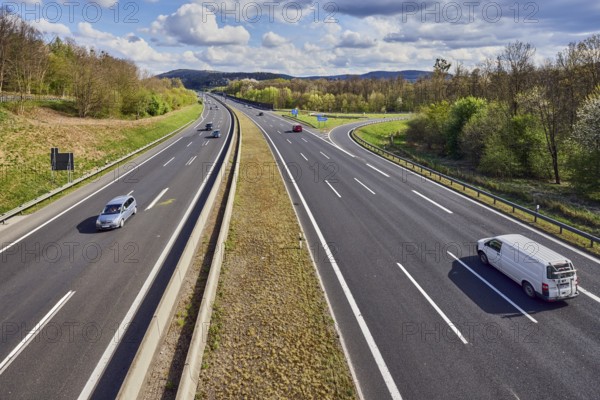 Hilly landscape, motorway exit AS Bessenbach Waldaschaff, lanes, guide post, guardrail, medium green, forest, blue partly cloudy sky, cumulus clouds, cumulus congestus clouds, vehicles, A3 motorway, Bessenbach, Lower Franconia, Aschaffenburg district, Bavaria, Germany