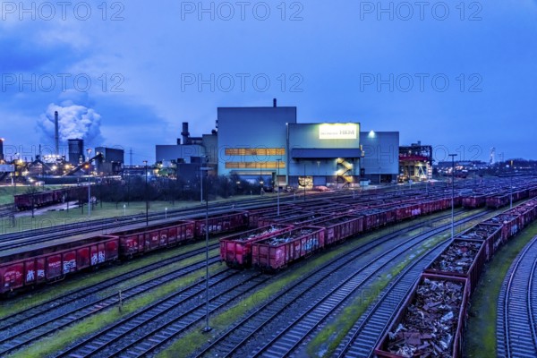 Hüttenwerke Krupp-Mannesmann, HKM in Duisburg, houses of the blast steel plant, coking plant, extinguishing tower with fire cloud, marshalling yard tracks, freight wagon with scrap metal, for melting down, North Rhine-Westphalia, Germany