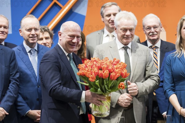 Kai Wegner (Governing Mayor of Berlin) holds a bouquet of tulips in the Hall of the Netherlands during the opening tour of the Green Week at the exhibition grounds in Berlin on 16 January 2026. The trade fair for the agricultural and food industry will take place from 16-25 January 2026