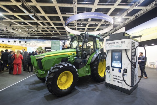 The prototype of an electric John Deere E-Power tractor is standing next to a charging station during the opening tour of the Green Week exhibition center in Berlin on 16.01.2026. The tractor has several batteries with a total of 115 kWh and, according to the manufacturer, is comparable to diesel tractors in all functions. The Agricultural and Food Industry Fair will take place from January 16-25, 2026