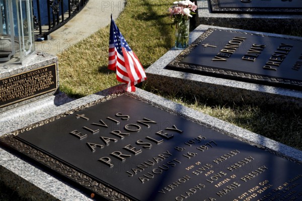 Engraved grave slabs of Elvis Presley with an American flag, Memphis, Tennessee, USA