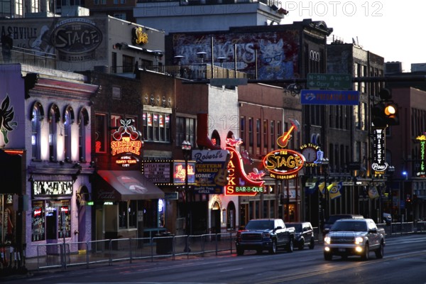 Broadway street lights at night with cars passing by, Nashville, Tennessee, USA