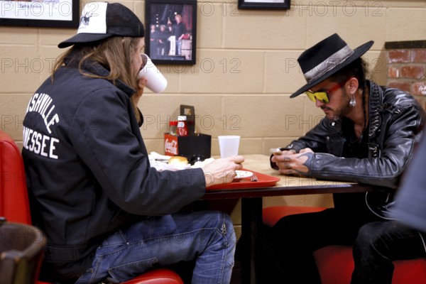 Two people eat and talk at a table in Arnold's Country Kitchen, Nashville, Tennessee, USA
