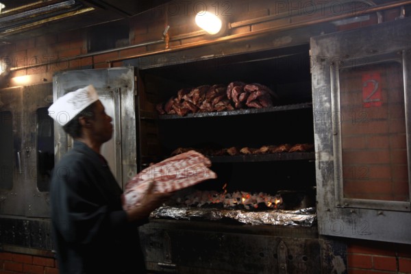 Chef prepares BBQ at Charlie Vegos' Rendezvous in Memphis, Memphis, Tennessee, USA