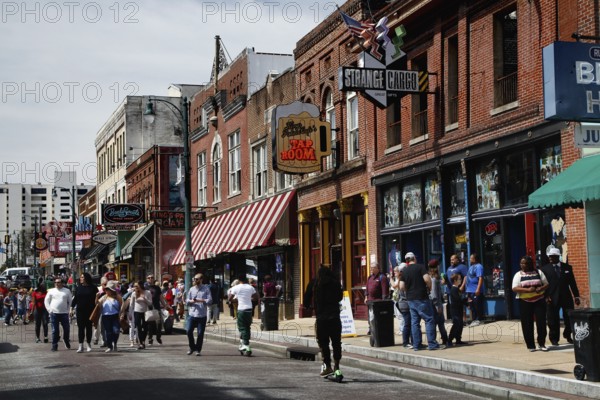 Bustling Beale Street with strollers and shops in Memphis, Memphis, Tennessee, USA