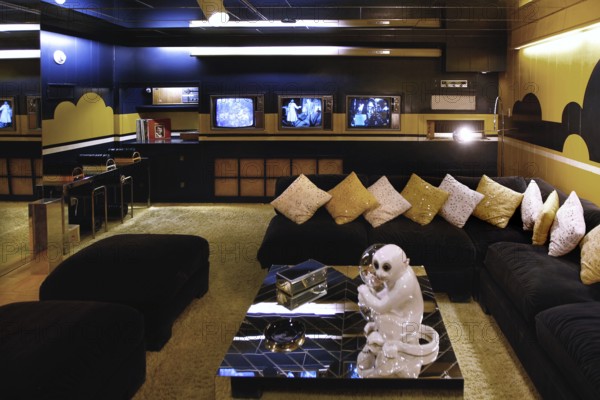 Stylish living room with plenty of pillows and television sets, in Graceland, Memphis, Tennessee, USA