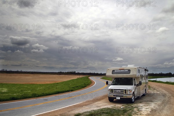 Motorhome on a winding country road under cloudy sky in Mississippi, Mississippi, zero, USA
