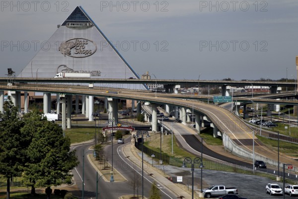 Futuristic pyramid next to a complex network of roads and bridges, Memphis, Tennessee, USA