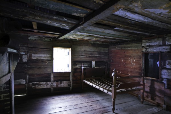 Wooden interior of a slave shelter with light coming through a window, Charleston, South Carolina, USA