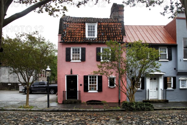 Charming, colorful house with historic flair under trees in Charleston, Charleston, South Carolina, USA