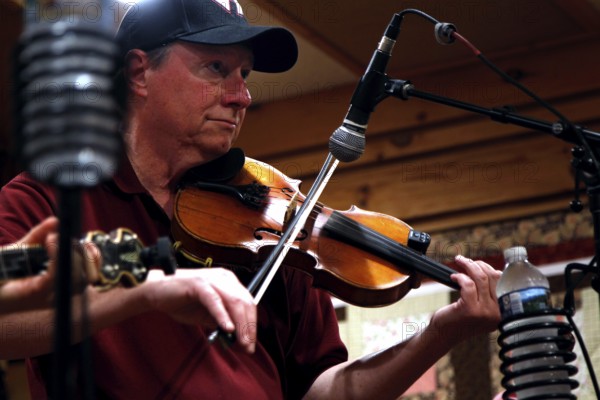 A musician with a violin during a performance at Floyd Country Store, Floyd, Virginia, USA