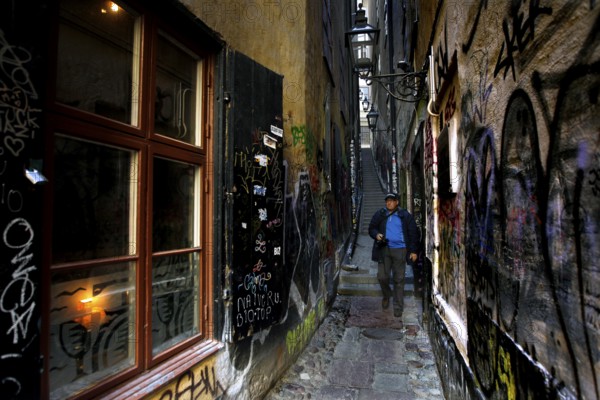 Narrowest alley in Gamla Stan with colorful graffiti and historic charm, Stockholm, Gamla Stan, Sweden