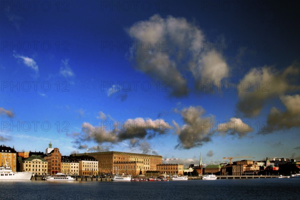 View of Stockholm harbor against an impressive blue sky with white clouds, Stockholm, Gamla Stan, Sweden