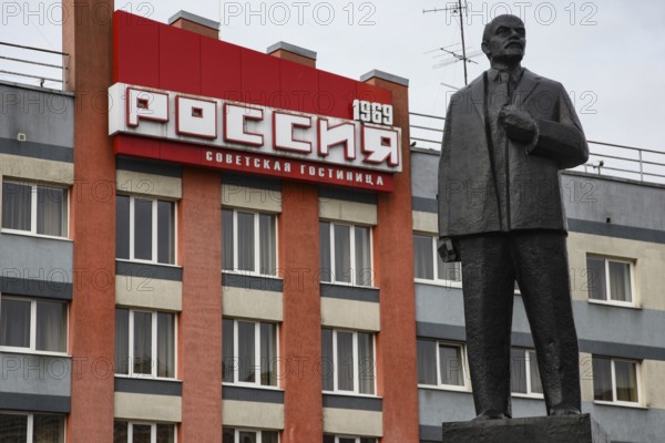 Large statue in front of a building with prominent lettering, Sovetsk, Kaliningrad, Russia