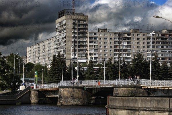 Large residential building with river and bridge in the foreground, Kaliningrad, Russia