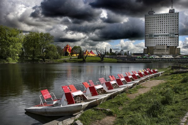 Boats on the castle pond with the imposing House of Councils in the background, Kaliningrad, Kaliningrad, Russia