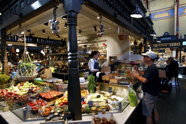 Lively market hall in Östermalm with a variety of food stalls and hustle and bustle, Stockholm, Östermalm, Sweden