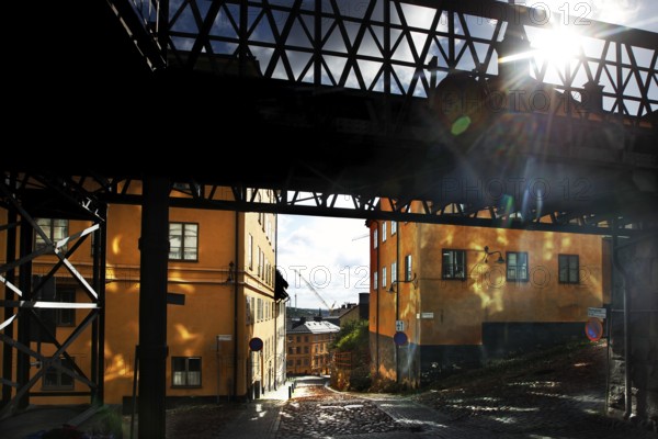 Bright buildings in Södermalm, Stockholm, in sunlight under a bridge, Stockholm, Södermanland, Sweden